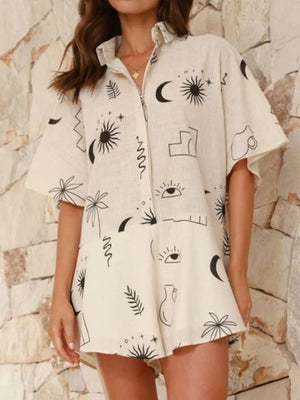 Beige linen romper with celestial print, buttoned collar, and flared hem.