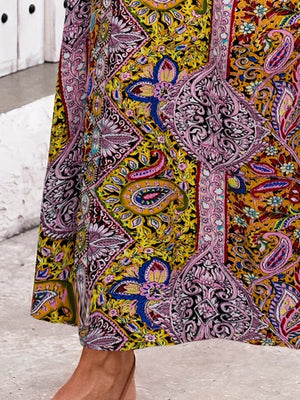 Paisley print maxi skirt in yellow-green with a side slit and bohemian pattern.