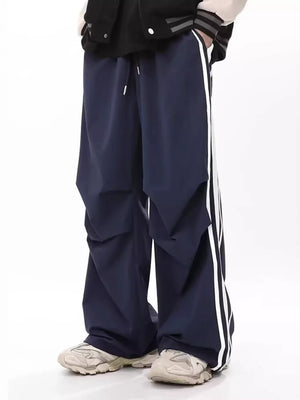 Navy wide-leg sweatpants for men with white side stripes and drawstring waist.