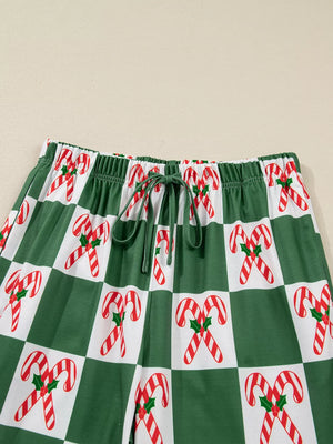 Green checkered pajama pants with candy cane print and drawstring waist