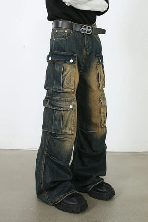 Distressed medium wash denim cargo pants with multiple flap pockets and a relaxed fit.