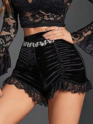 Black velvet high-waisted shorts with ruched detailing and lace trim.