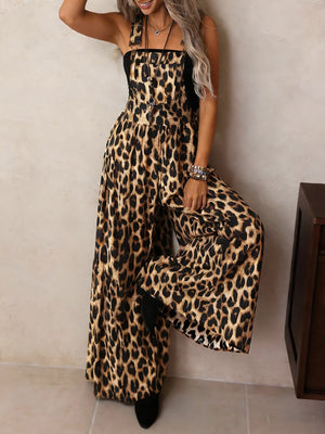 Leopard print wide leg romper with adjustable straps and buckle hardware.