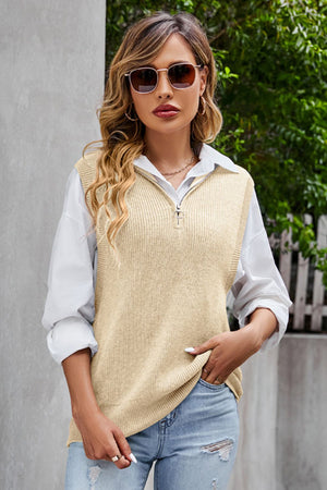 Tan ribbed knit vest with quarter zip and collar, worn over a white shirt.