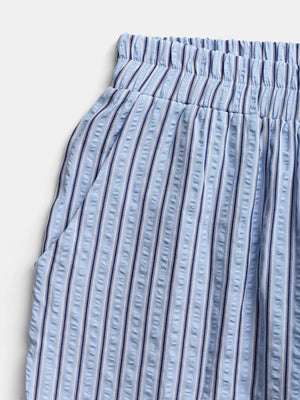 Maternity wide-leg pants in blue and white vertical stripes with an elastic waistband and side pocket detail.