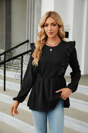 Black textured ruffle peplum blouse with long sleeves and a round neckline.