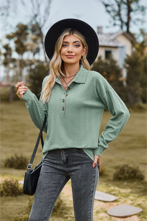 Sage green textured knit polo shirt with buttoned placket and long sleeves