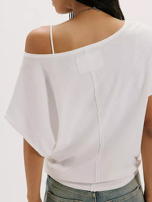 White asymmetrical relaxed fit t-shirt with dolman sleeves and a cropped length.
