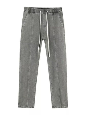 Relaxed fit grey cotton jeans with drawstring and front seams.
