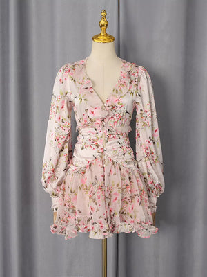 Charming ruffled floral mini dress with V-neck, long sleeves, and button detail.