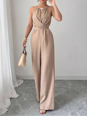 Beige halter neck wide leg jumpsuit with wrap detail and drawstring waist.