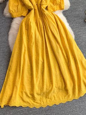 Yellow lace-embellished A-line midi dress with puff sleeves and scalloped hem.