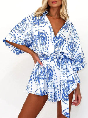 Blue celestial print wrap romper with short sleeves and tie waist