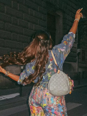 Denim button-up shirt with colorful artistic paint splatters, long sleeves, relaxed fit.