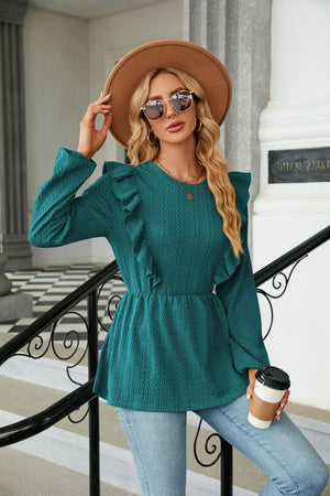 Teal textured ruffle peplum blouse with long sleeves and a round neckline.