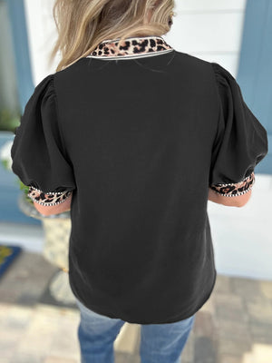 Black puff sleeve blouse with leopard trim collar and cuffs