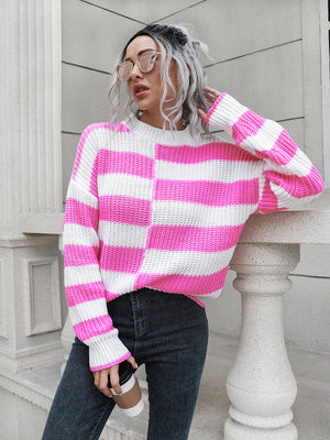 Fuchsia pink and white striped acrylic sweater with crew neck and long sleeves.