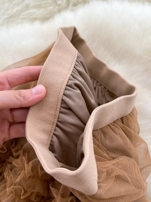 Brown tulle skirt with elastic waistband and ruffled tiers.