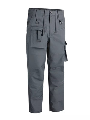 Men's grey functional cargo pants with multiple pockets and buckle details.