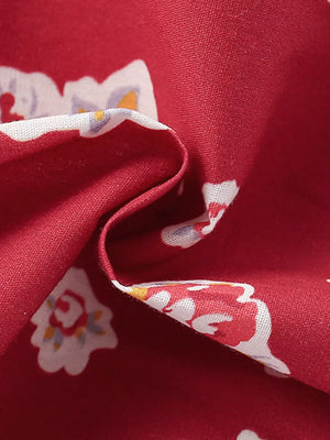Red cotton baby dress with a white floral print and a ruffled collar detail.