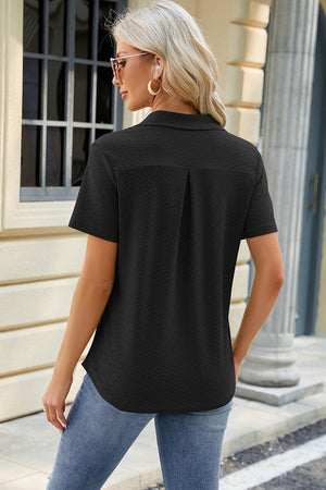 Black textured polo shirt with V-neck detail and short sleeves.