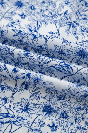 Maxi dress in white with a blue floral print and knot detail