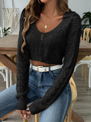 Black cropped pointelle knit polo top with V-neck and long sleeves.