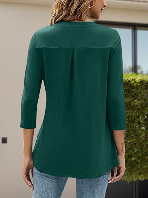 Dark green three-quarter sleeve top with V-neck and back pleat detail