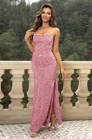 Sequin cami gown in strawberry with spaghetti straps and a high slit.