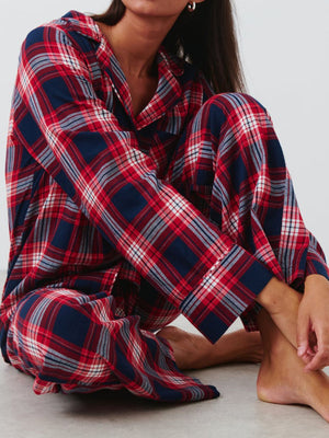 Crimson plaid pajama set with button-up top and relaxed fit pants, 100% polyester.