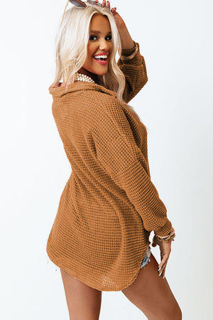 Caramel waffle knit button-down shirt jacket with collared neckline and long sleeves.