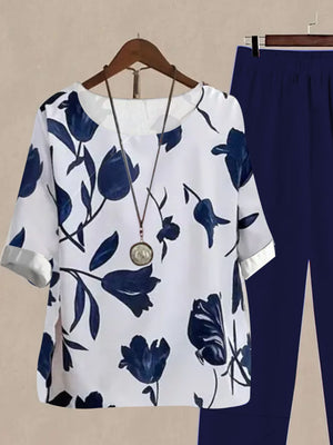 Floral print half sleeve top and dark blue pants set with round neckline and cuff sleeves.