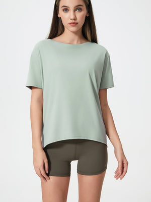 Relaxed fit light green performance tee with short sleeves and boat neck.