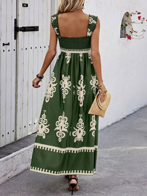 Dark green maxi dress with smocked bodice, square neck, ruffled straps, and ornate print.