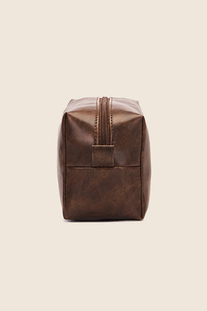 Textured faux leather travel case in caramel with a zipper closure and carry handle.