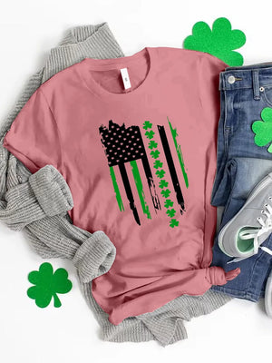 Pink t-shirt with distressed American flag graphic featuring shamrocks and green stripes.