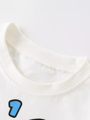 White cotton crew neck t-shirt with blue cartoon rocket graphic detail.