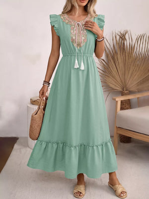 Maternity maxi dress in green with embroidered tie neck, ruffle sleeves and hem.