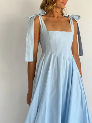 Light blue maxi dress with square neckline and bow-tie shoulder straps.