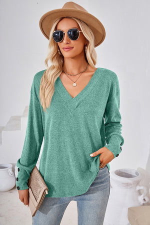 Button-cuff slouch v-neck top in Matcha Green with button detail on sleeves.