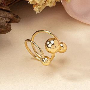 Gold alloy multi-layered ball ring with three polished spheres.