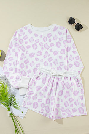 Pink leopard print loungewear set with crewneck top and drawstring shorts.