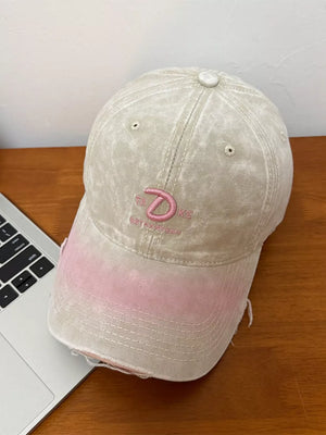 Embroidered vintage denim baseball cap in khaki with pink ombre brim and distressed details.