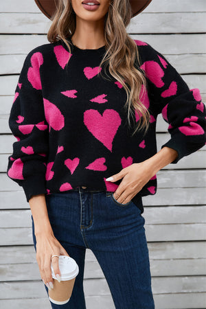 Black acrylic blend sweater with pink heart intarsia pattern and crew neck.