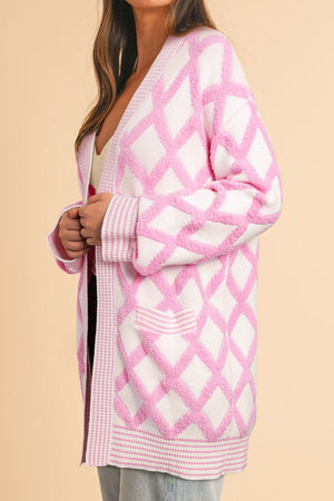 Diamond jacquard knit open cardigan in blush pink with textured diamonds and contrast trim.