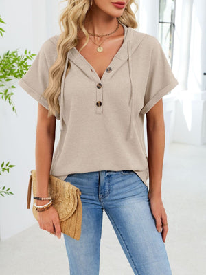 Apricot waffle knit hooded top with short sleeves and button placket.