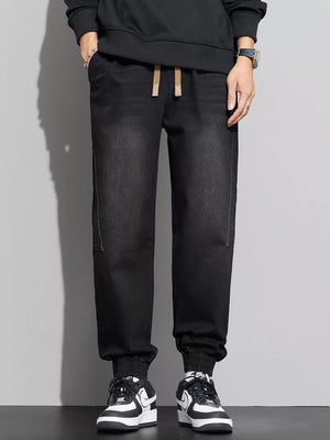 Black cotton denim joggers with drawstring waist and elastic cuffs