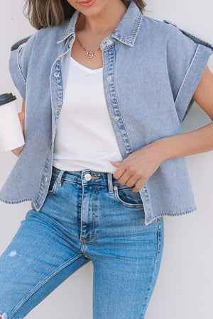 Light blue denim rolled-sleeve shirt jacket with button front and collar.