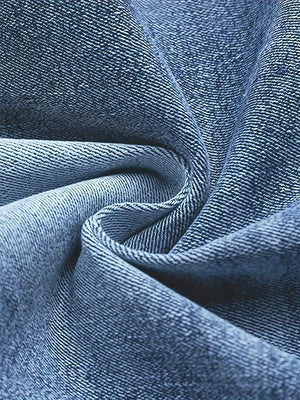 Blue cotton denim fabric detail, showing texture and weave.