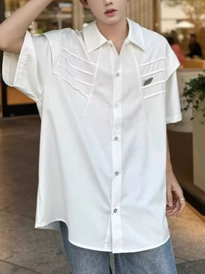 White relaxed fit oversized button-up shirt with chest pleats and short sleeves.